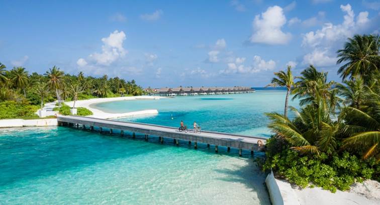Couple cycling on the island - Niyama Private Islands Maldives
