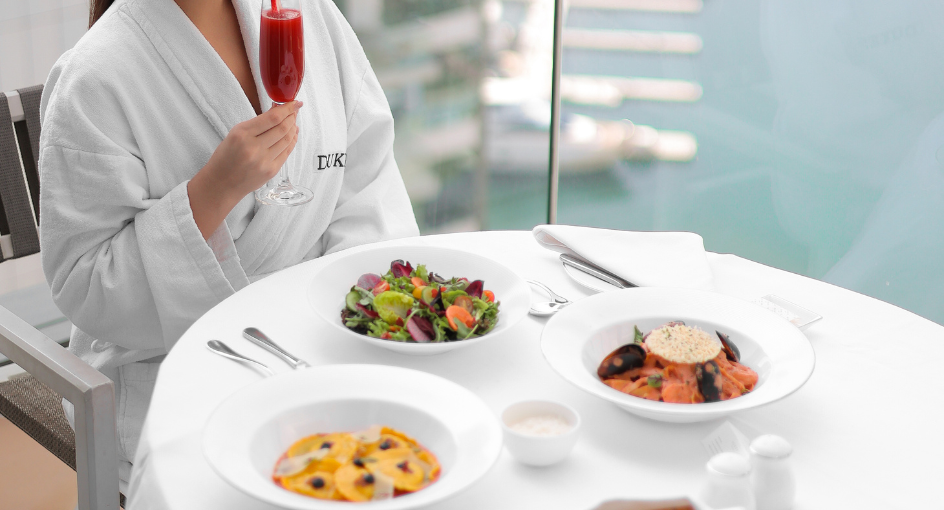A lady enjoying an in-room dining breakfast